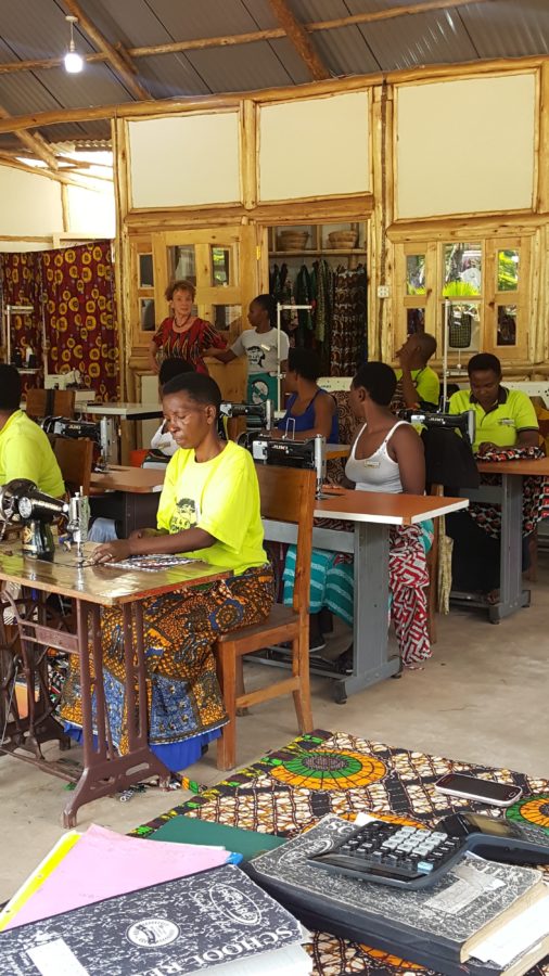 Women gathered at the Ride 4 A Woman community centre near Bwindi Impenetrable Forest, Uganda, supported by Deeper Africa safaris
