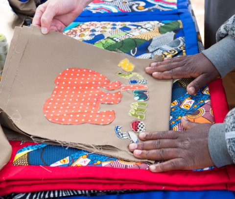 Women of the Thandanani Sewing Project at work near Hwange National Park, Zimbabwe, producing handcrafted goods sold to safari visitors