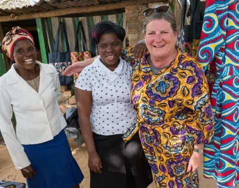 Community gathering of Thandanani Sewing Project members near Hwange National Park, Zimbabwe — women's cooperative supported by Deeper Africa safaris