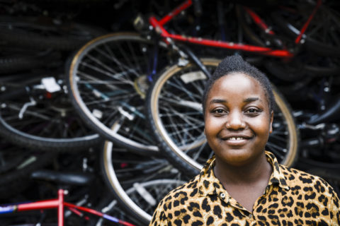 Women and visitors at Ride 4 A Woman community centre near Bwindi Uganda — cultural exchange on a Deeper Africa safari